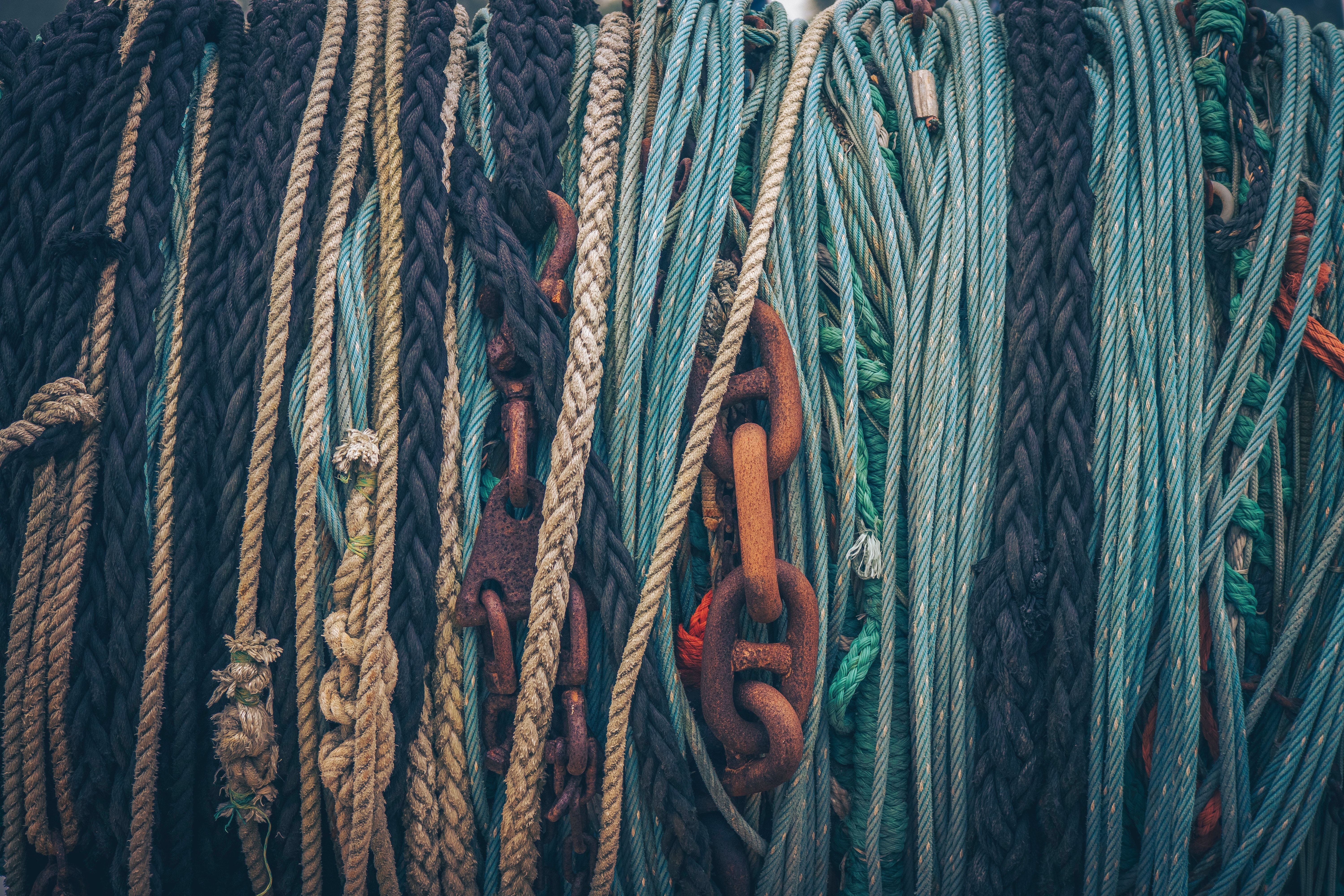 An image of ropes and chains hanging together.